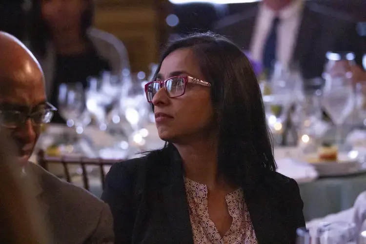 Amber Khan, panelist at the Beyond Religion Conference and executive producer and host of Interfaith Voices, listens intently as Oppenheimer and Mogahed share their perspectives on interfaith collaboration and reporting on violence and tragedy. Image by Jin Ding. United States, 2019.