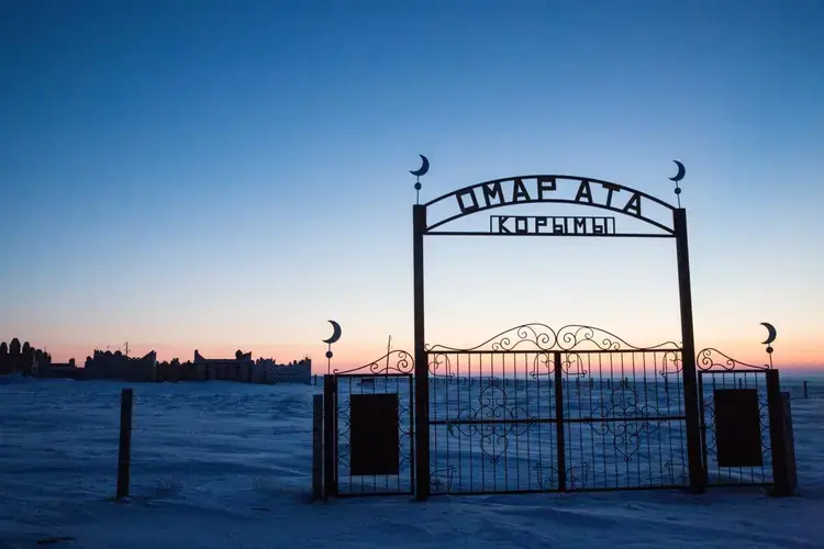 A Muslim graveyard is seen at sunrise near Tastubek. Image by Taylor Weidman. Kazakhstan, 2017.