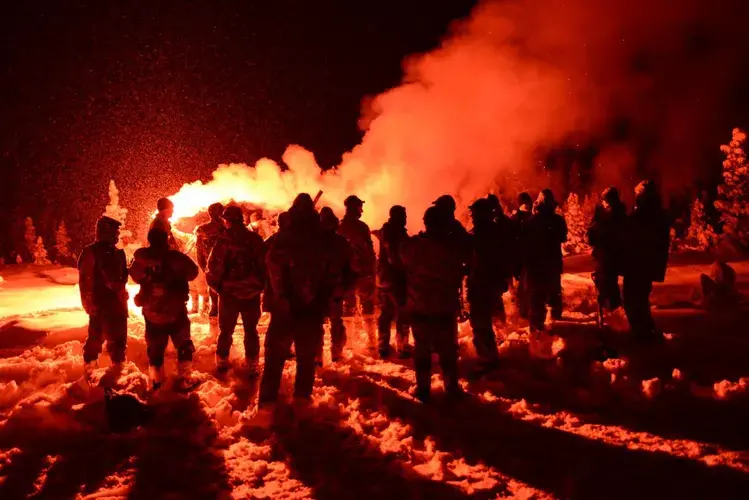 Air crews learn how to use emergency flares during cold weather survival training at the U.S. military’s Northern Warfare Training Center in Black Rapids, Alaska. Image by Louie Palu. United States, 2018.