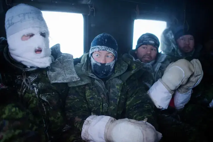 Frost-faced members of a Canadian aircrew head back to hot meals and showers after enduring a week of temperatures as low as -60°C during an outdoor survival course. Image by Louie Palu. Canada, 2018.