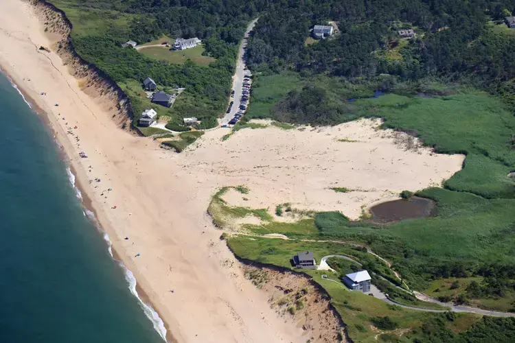 Ballston Beach from the air looks a bit like a battle scar, the dunes flattened by frequent storms. Image by John Tlumacki. United States, 2019.