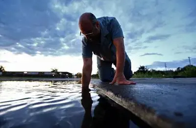 Norman Levine, director of the College of Charleston’s Lowcountry Hazards Center, studies tidal flooding on Charleston’s East Side. Image by Tony Bartelme/The Post and Courier Staff. United States, undated.