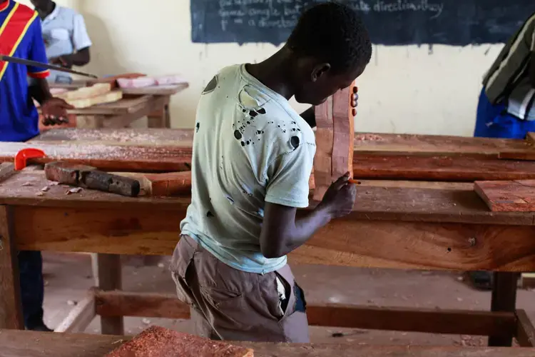 A boy who was in an armed group learning carpentry at a vocational training centre ran by UNICEF outside the city of Yambio. Image by Andreea Campeanu. South Sudan, 2018.