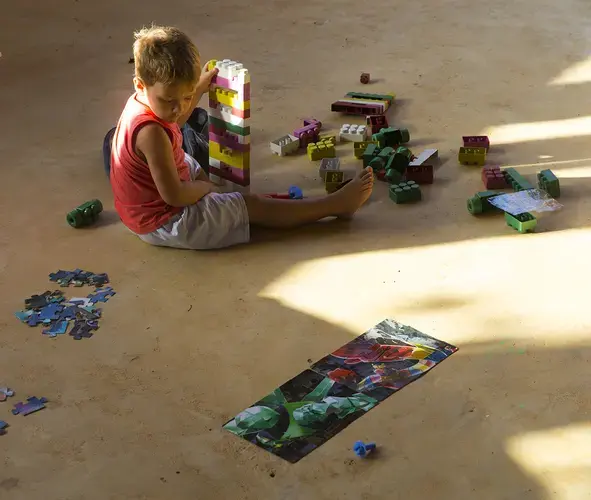 Vitor Hugo Braun, 3-year-old son of yellow fever victim Virlei Braun, plays by himself at his paternal grandparent's home in São João Pequeno. Image by Mark Hoffman. Brazil, 2017.