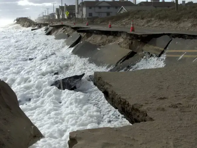 Waves lap at N.C. 12 in Kitty Hawk at low tide Oct. 10, 2016. This section has since been repaired. Image by Kip Tabb. United States, 2016.<br />