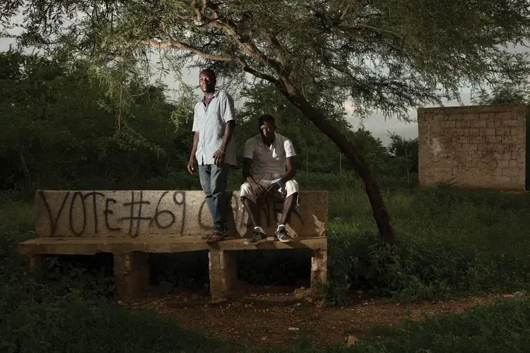 Evenson Louis (left) and Accene Appolon in a park they helped to preserve in the neighborhood of Canaan 1. Evenson actively protects greenspaces for the community. Image by Allison Shelley. Haiti, 2017.<br />
