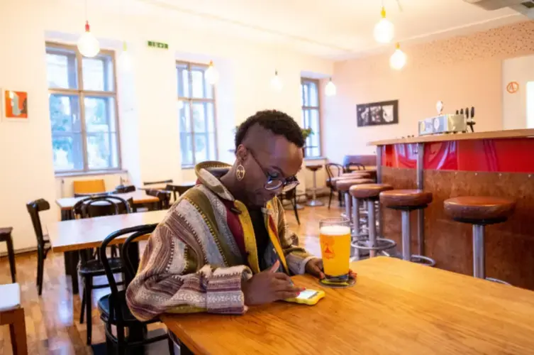 After finishing work at 'Queer Base' in Vienna, Faris has a beer in the queer friendly
space Villa Vida in central Vienna, Austria's capital. Image by Bradley Secker. Austria, 2020.