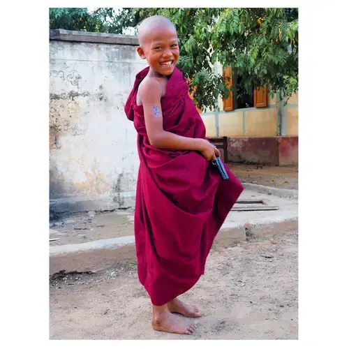 A young monk plays with a toy pistol. Image by Doug Bock Clark. Myanmar, 2018.