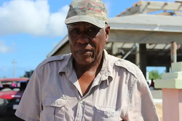 'Barbuda land is not for sale,' insists Clifton Walbrook as he stands outside his house wrecked by Hurricane Irma on November 17, 2017. An estimated 90 percent of properties were damaged in Barbuda when the Caribbean island was hit by Irma on Sept, 6, 2017. Image by Gregory Scruggs. Barbuda, 2017.
