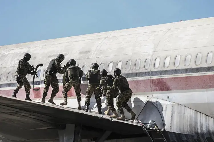 Botswana Defense Force Commandos remove hostages and hijackers from an airplane during a training exercise at Thebephatshwa Air Base in Botswana on July 17, 2019. The exercise was part of a two-day culminating event that included a simulated airplane. Image courtesy of the U.S. military's press photos. Botswana, 2019.
