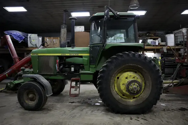 A John Deere tractor is seen at Darian Acres dairy farm in Rio, Wis., on Dec. 18, 2020. Image by Coburn Dukehart / Wisconsin Watch. United States, 2020.