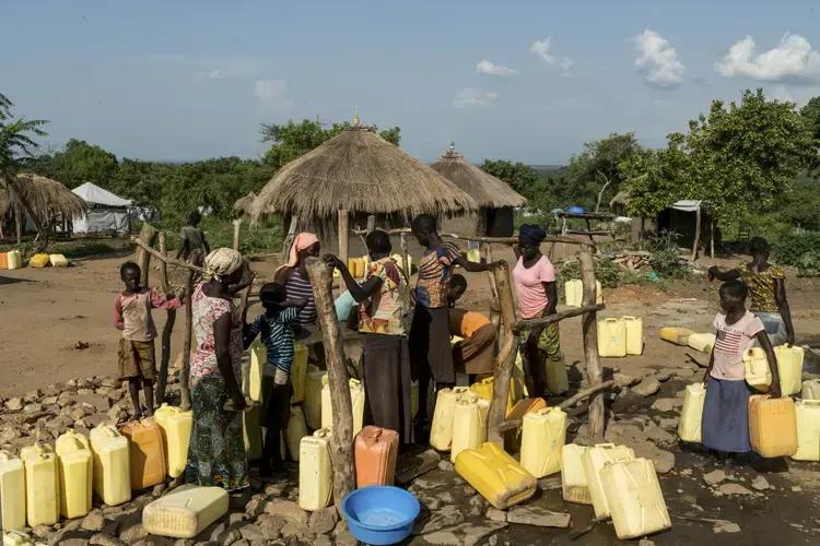 Women collect water from a borehole in the Omugo camp for refugees that have fled from South Sudan to Uganda.