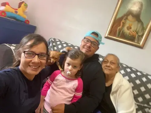 Deborah Oquendo with her family at her home in Orlando, Florida. Image courtesy of Center for Investigative Journalism. United States, undated.