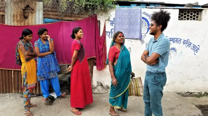 Suraj Yengde in his neighborhood, encouraging Dalit women to try to continue their education, in spite of institutional barriers. Image by Phillip Martin/WGBH News. India, 2019.