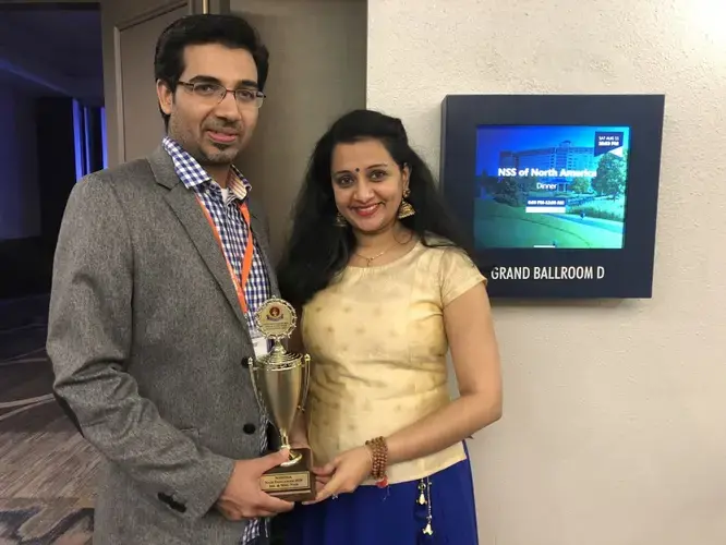 Sujith Kenoth (left) and Swapna Nair, the husband-wife pair who won the title of 'Mrs. and Mr. Nair' at the 2018 Nair convention. Image by Kavita Pillay/WGBH News. India, 2018.