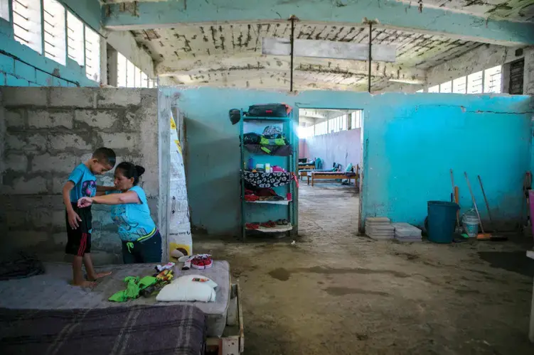 Faces of Chiapas | Tapachula is a busy migrant hub in Mexico’s southwestern state of Chiapas. At left, Sandra Herrera and her son, Angel, are staying there in the Todo Por Ellos migrant shelter. Image by Jose Cabezas. Mexico, 2018.