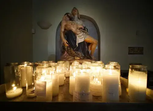 Candles flicker in the Dulce Nombre de Maria Cathedral Basilica in Hagatña, Guam. Image by Cory Lum. Guam, 2017.