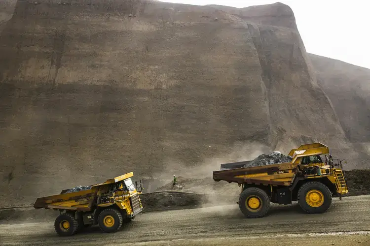 Dump trucks carry waste from a company mining site in Hpakant Township on May 21, 2019. Image by Hkun Lat/Frontier. Myanmar, 2020.