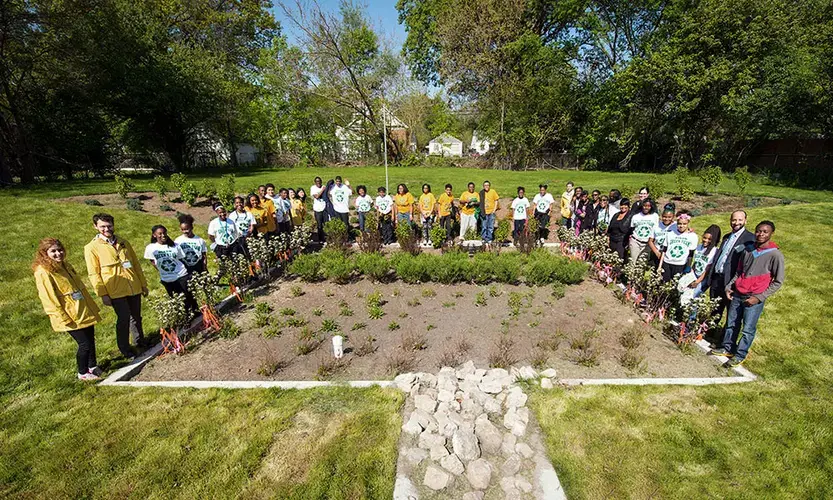 Community leaders, project partners and local residents celebrate the installation of a bioretention garden on a vacant lot in Detroit in May 2016. All together, four such gardens were expected to cut stormwater flow by 1.2 million gallons per year, reducing street flooding and water pollution. Image by University of Michigan School for Environment and Sustainability / Flickr. United States, 2020.