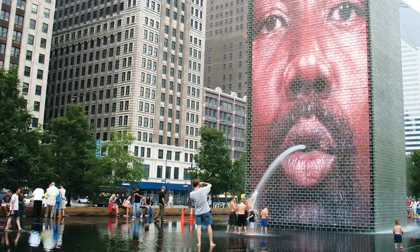The Crown Fountain in Chicago’s Millennium Park offers welcome relief to heat-stressed residents. Image by Jaume Plensa / Flickr. United States, undated.