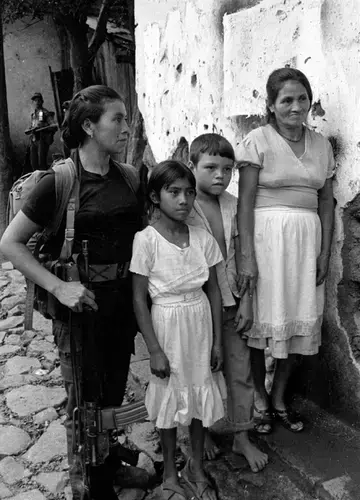 ERP combatant with civilians in Perquín. Image courtesy Linda Hess Miller. El Salvador, 1990.