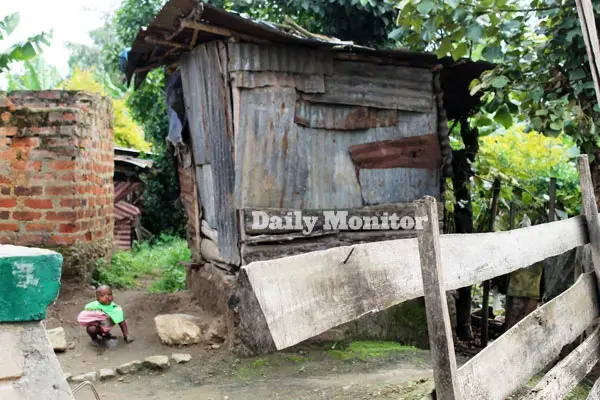 A child defecates near a toilet in Karago town council. Open defecation is common in the area. Image by Felix Basiime. Uganda, undated.