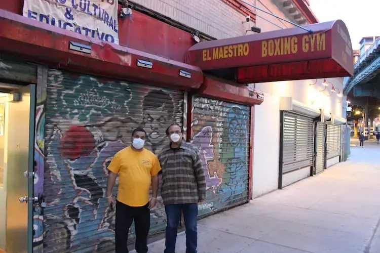 Fernando Laspina Franco and Armando Pacheco Matos in front of the El Maestro Cultural and Educational Center in the Bronx. Image by Coral Murphy / Center for Investigative Journalism. United States, 2020.