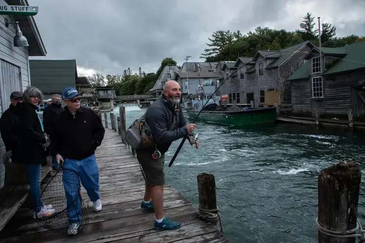 A man fishes for salmon at Fishtown in Leland, Michigan, on Oct. 1, 2020. Image by Zbigniew Bzdak/Chicago Tribune. United States, 2020.