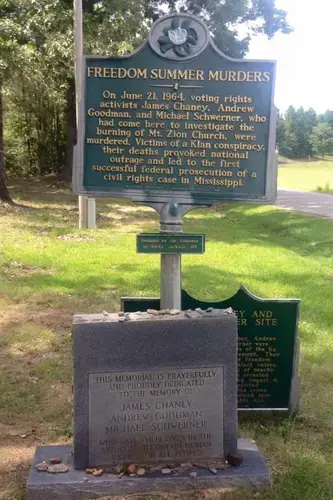 A headstone memorial outside of the reconstructed Mt. Zion Baptist Church in Philadelphia, Mississippi. Image by C. Zawadi Morris. United States, undated.<br />
