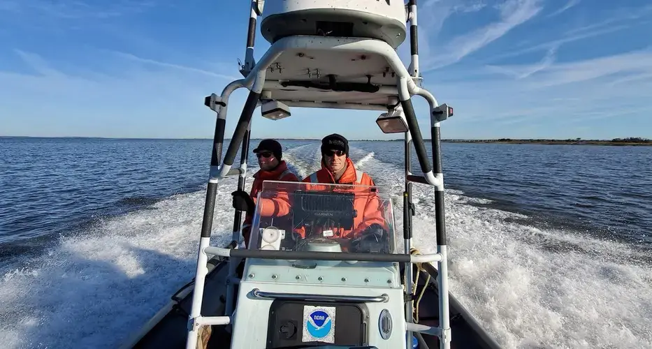 Clay George, left, and Trip Kolkmeyer, wildlife biologist with the Georgia Department of Natural Resources, aboard a NOAA Zodiac. Image by David Abel/The Boston Globe Staff. Canada, 2019.