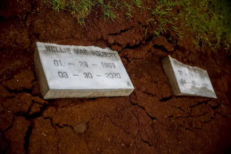 Nellie 'Pollye Ann' Mae and Benjamin Tolbert, a couple married for 30 years, are laid to rest at Cedar Hill Cemetery on Saturday, April 18, 2020, in Dawson, Ga. Both Nellie and Benjamin Tolbert died two days apart from each other in separate hospitals from COVID-19. Image by Brynn Anderson / AP Photo. United States, 2020.