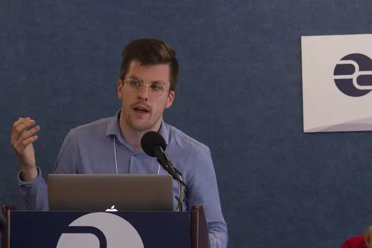 On the refugees and migration panel at the Gender Lens conference, grantee and freelance photographer Jake Naughton speaks about his reporting on LGBT refugees from Uganda who have fled to Kenya. Image by Jin Ding. United States, 2017.