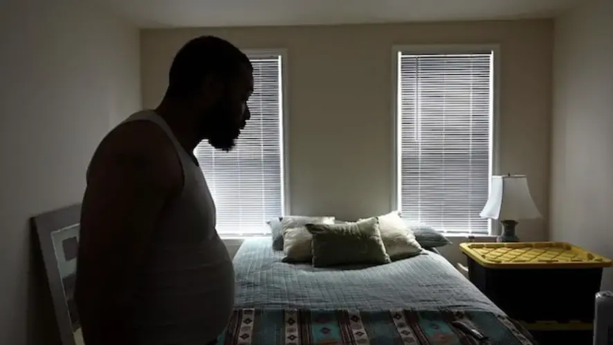 Arthur Gilliam says he rented an East Baltimore rowhouse that is big enough for his five kids to visit. It is among the steps he has taken to get his life on track after serving time in prison and racking up some $40,000 in child support debt. Image by Lloyd Fox / Baltimore Sun. United States, undated.