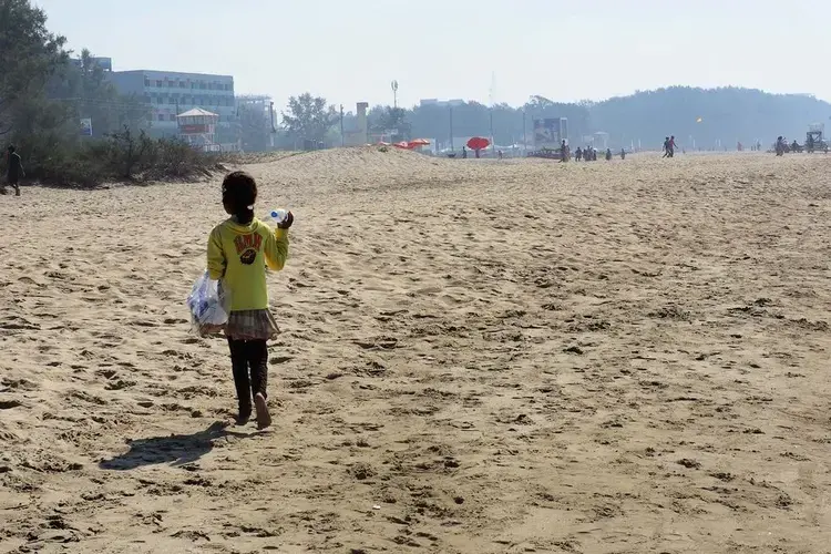 Six-year-old Firefly sells water bottles on the beach. Image by Doug Bock Clark. Bangladesh, 2017. 