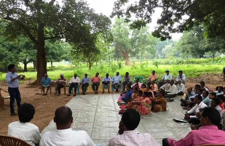 Gladson Dundung (left) during a village meeting on land and forest policies in Khunti, Jharkhand. Khunti, Jharkhand. June 2019. Image by Chitrangada Choudhury.