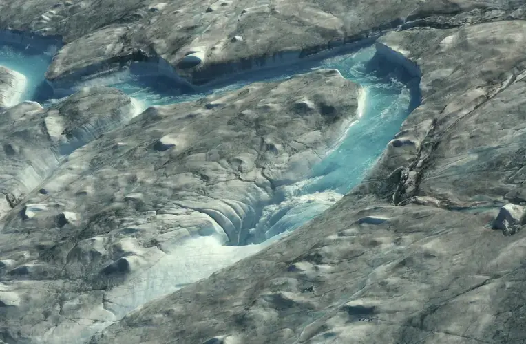A heat wave in 2019 hit Greenland, accelerating the melting of the island's ice sheet and causing massive ice loss in the Arctic. Image by Caspar Haarløv / AP. Greenland, 2019.