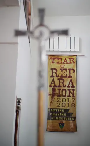 A banner proclaims 2017-2018 the Year of Reparation inside Mount Carmel Church in Agat, Guam, where Quintanilla and Sondia were once altar boys. Image by Cory Lum. Guam, 2017.
