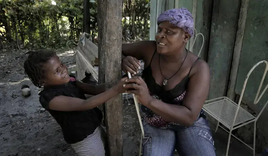 Paula Paul, 44, has been diagnosed with advanced cervical cancer. She constantly worries about what will happen to daughter, Marie Stacey, 6, once she’s gone. Image by José A. Iglesias. Haiti, 2018.