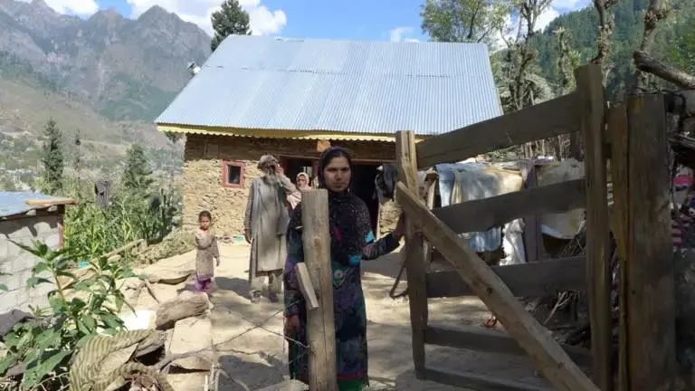 Rubela Bano, 27, says that traveling to the hospital was the toughest part of her three pregnancies. For most women in her village, the only way to the maternity ward is on a man's shoulders. Image by Safina Nabi. India, 2020.