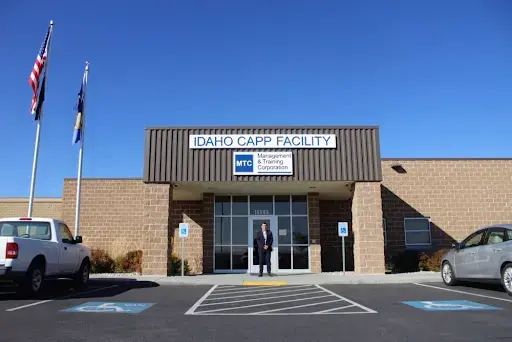 Warden Henry Atencio stands in front of Idaho's only in-state private prison. It's called the Idaho Correctional Alternative Placement Program, or CAPP, and it's run by Management and Training Corporation. Image by Madelyn Beck / Boise State Public Radio. United States, 2020.