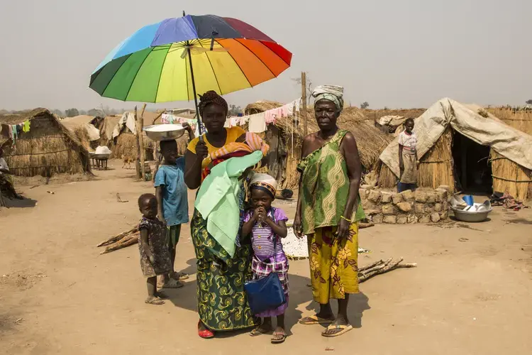 A family shelter from the midday sun in an IDP camp. Image by Jack Losh. Central African Republic, 2018.