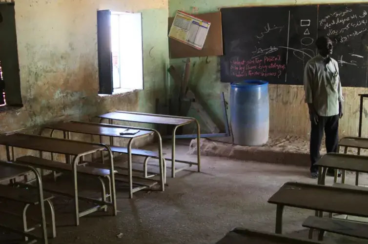 Elementary school teacher Abboud Kodi in Abdulbari’s fifth-grade classroom. Image by Rebecca Hamilton. Sudan, 2019.