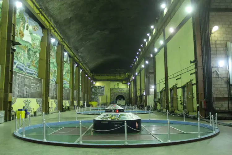 A look inside at the turbines in the Chhukha Hydropower Plant power station. Begun in 1979, Chhukha is the oldest hydropower plant in the country, and frequently needs repair due to its use of outdated Indian technology. Image by Emma Johnson. Bhutan, 2019.