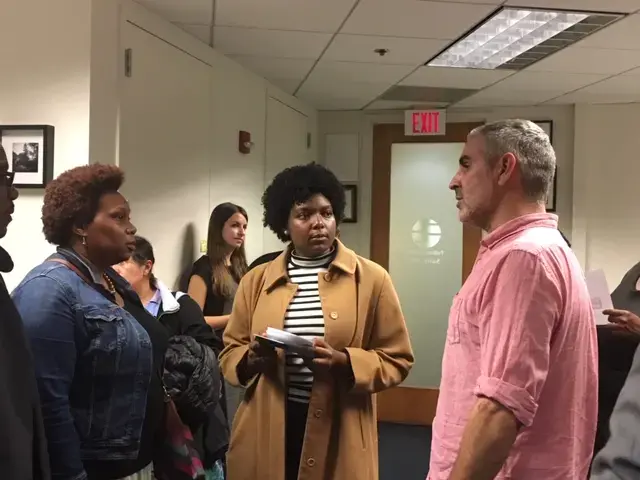 Louie Palu talks with Woodrow Wilson High School student Camille Pratt after the reception. Image by Fareed Mostoufi. United States, 2018.