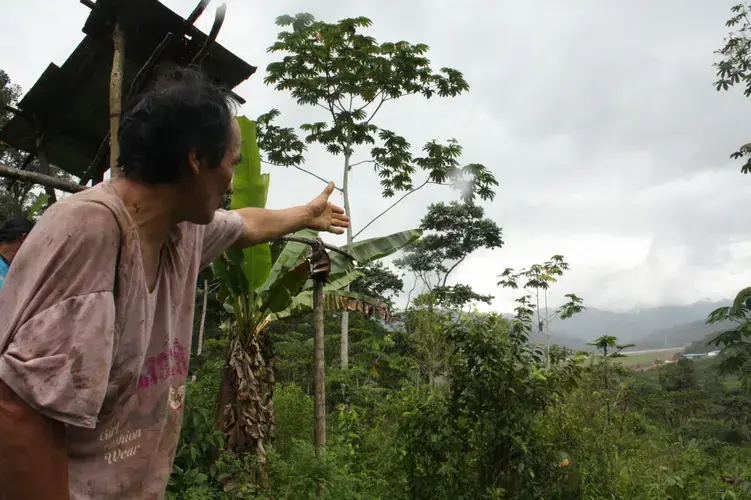 Manuel Mashendo, indigenous Shuar, points to where his family home was until they were evicted in February 2016. Image by Andrés Bermúdez Liévano. Ecuador, 2019.