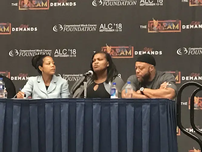 Indira Henard (right) listens to Beverly Walker (center) speak about her experience caring for her family while her husband Baron (right) was incarcerated. Image by Claire Seaton. Washington, D.C., 2018.