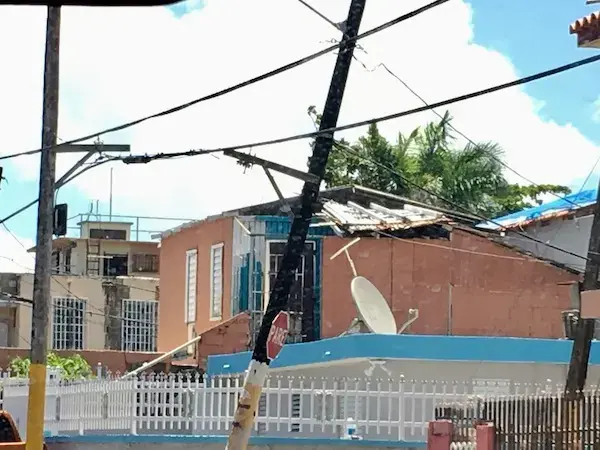 A house in the San Juan community of Shanghai remains unrepaired in April 2019, 19 months after Hurricane Maria. Image by Martha Bayne. United States, 2019.