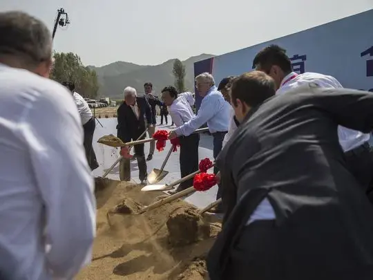 Rick Kimberley, farmer from Maxwell, Iowa, Qu Dongyu, China's Vice Minister of Agriculture and Terry Branstad, US Ambassador to China, break ground for the China-US Demonstration Farm in Luanping County, Hebei. The farm in China will be modeled after Kimberley's farm in Iowa. Image by Kelsey Kremer. China, 2017.