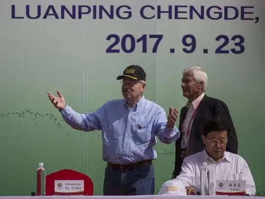Ambassador Terry Branstad and Rick Kimberley, an Iowa farmer, talk on stage during the groundbreaking of the China-US Demonstration Farm on Saturday, Sept. 23, 2017, in Luanping County, Hebei, China. The farm in China will be modeled after Kimberley's farm in Maxwell, Iowa. Image by Kelsey Kremer. China, 2017.