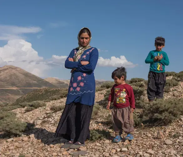 Marzieh Esmaeilpour, 33, watches over her sons. Marzieh and her husband sold most of their flock of goats and plan to use the money to help the family move to the city to allow her sons to attend school. Image by Newsha Tavakolian. Iran, 2018.